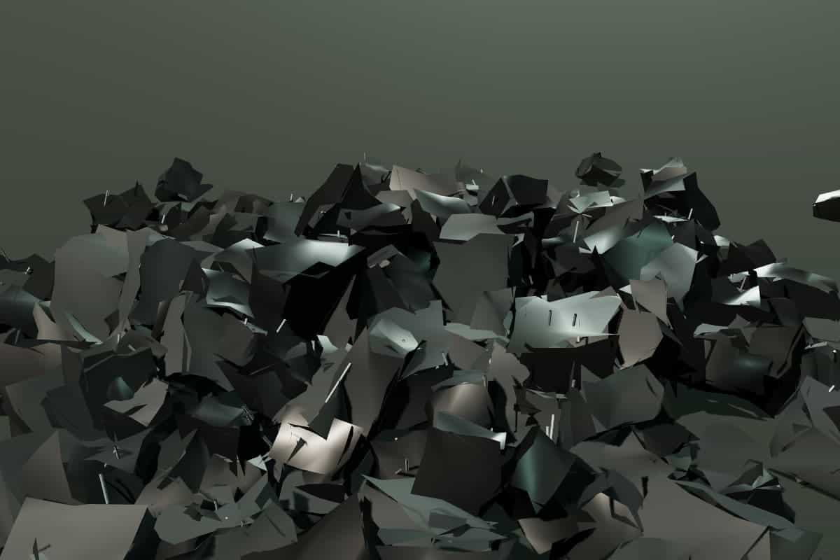 A heap of shredded scrap tire with steel belt wire showing at the cut edges